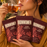 IronWomen Jujube Ginger Tea, three burgundy pouches and a warm cup of tea